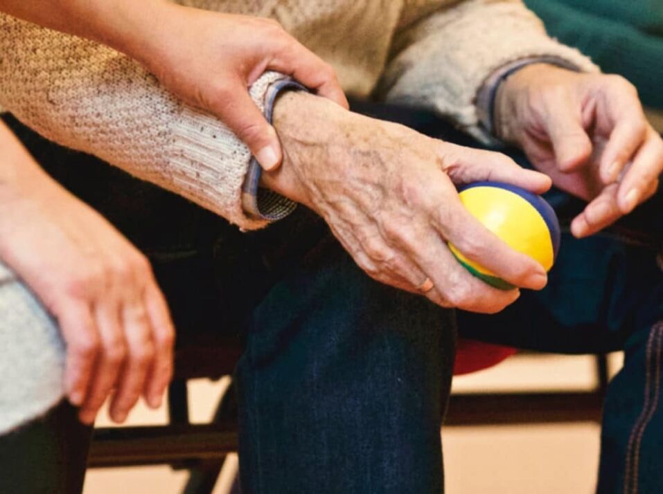 holding the hand of an elderly person
