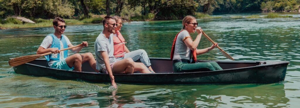 A group of people paddle through water